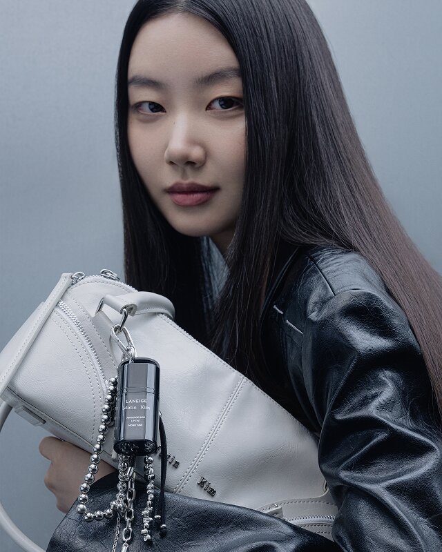 A Laneige x Matin Kim lip tint clipped to a white Matin Kim bag with a silver chain.